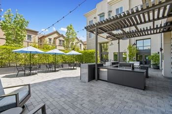 Outdoor patio grill and tables at aventine apartments in hercules, ca 94547